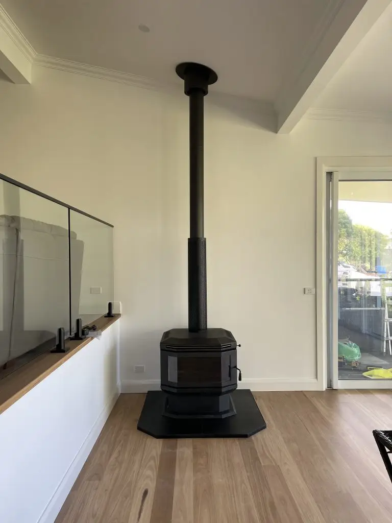 Fireplace with timber mantel and TV